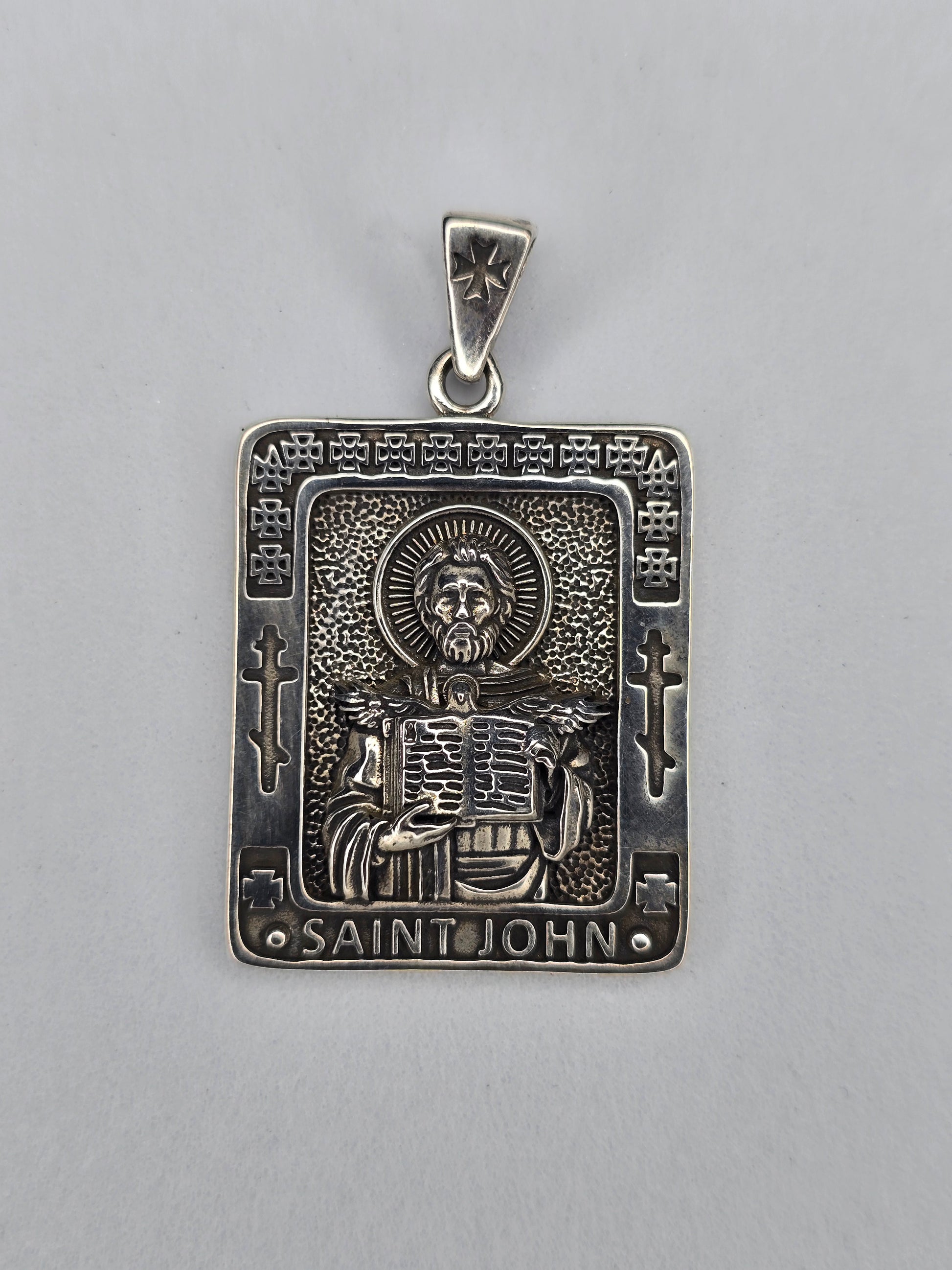 Saint John pendant in solid 925 sterling silver with engraved saint holding scripture