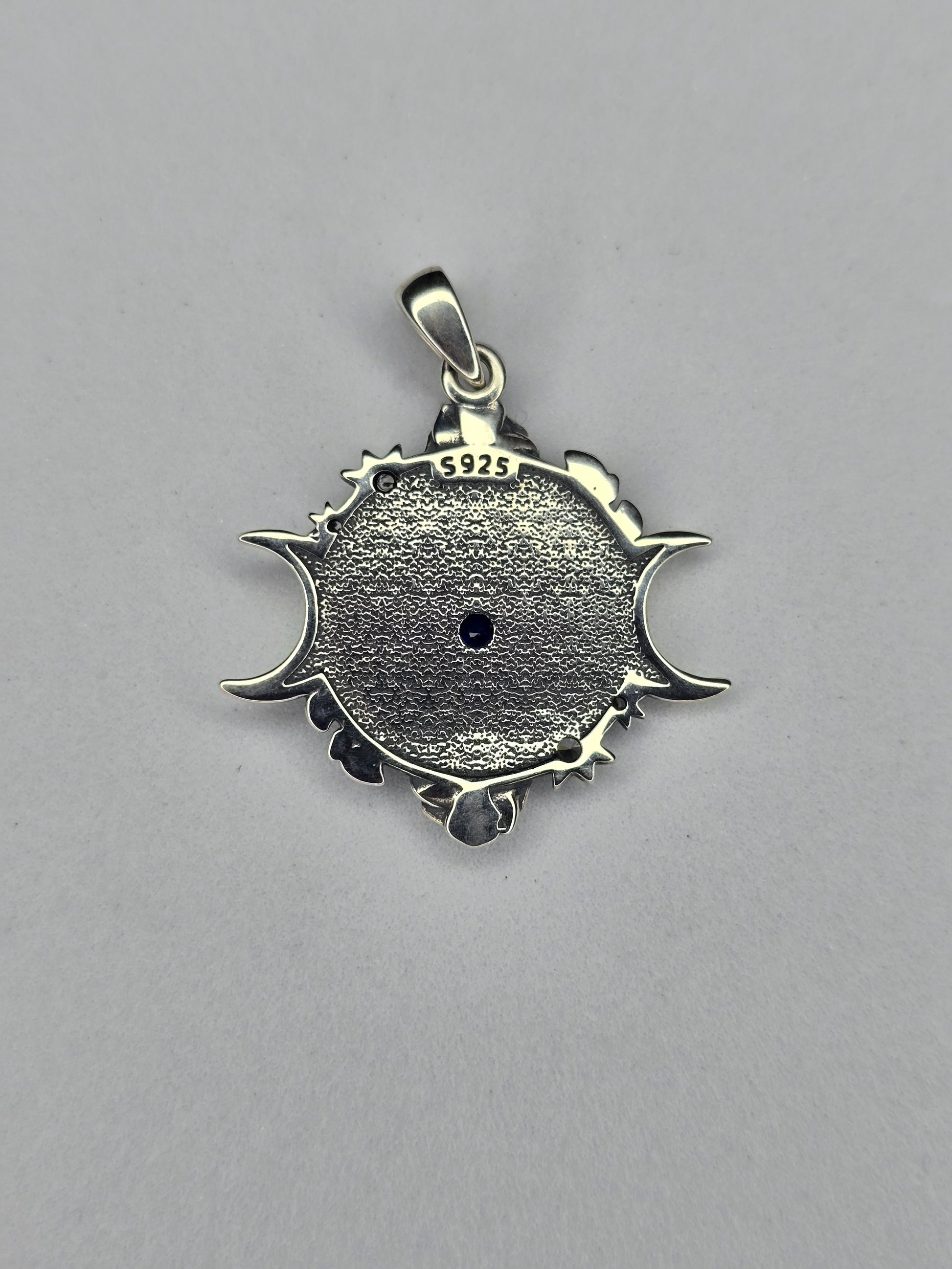 Back view of Eye of Horus triple moon pendant showing textured sterling silver finish