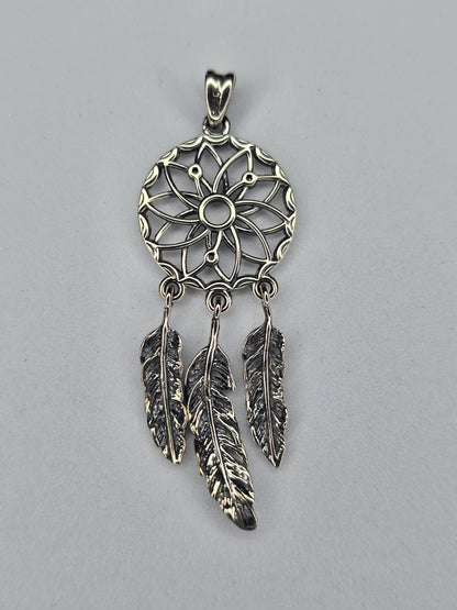 Back view of sterling silver dream catcher pendant with feather details and hallmark