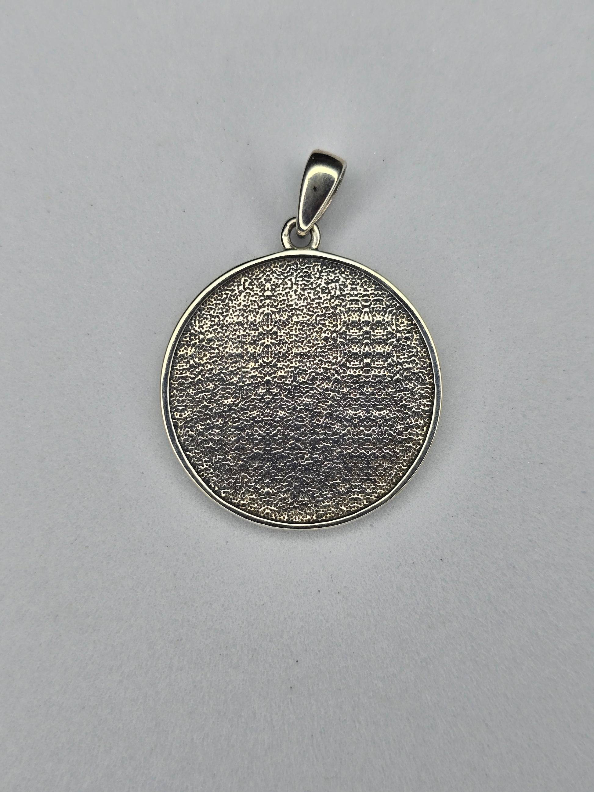 Back view of sterling silver Triple Goddess pendant with textured finish and 925 hallmark