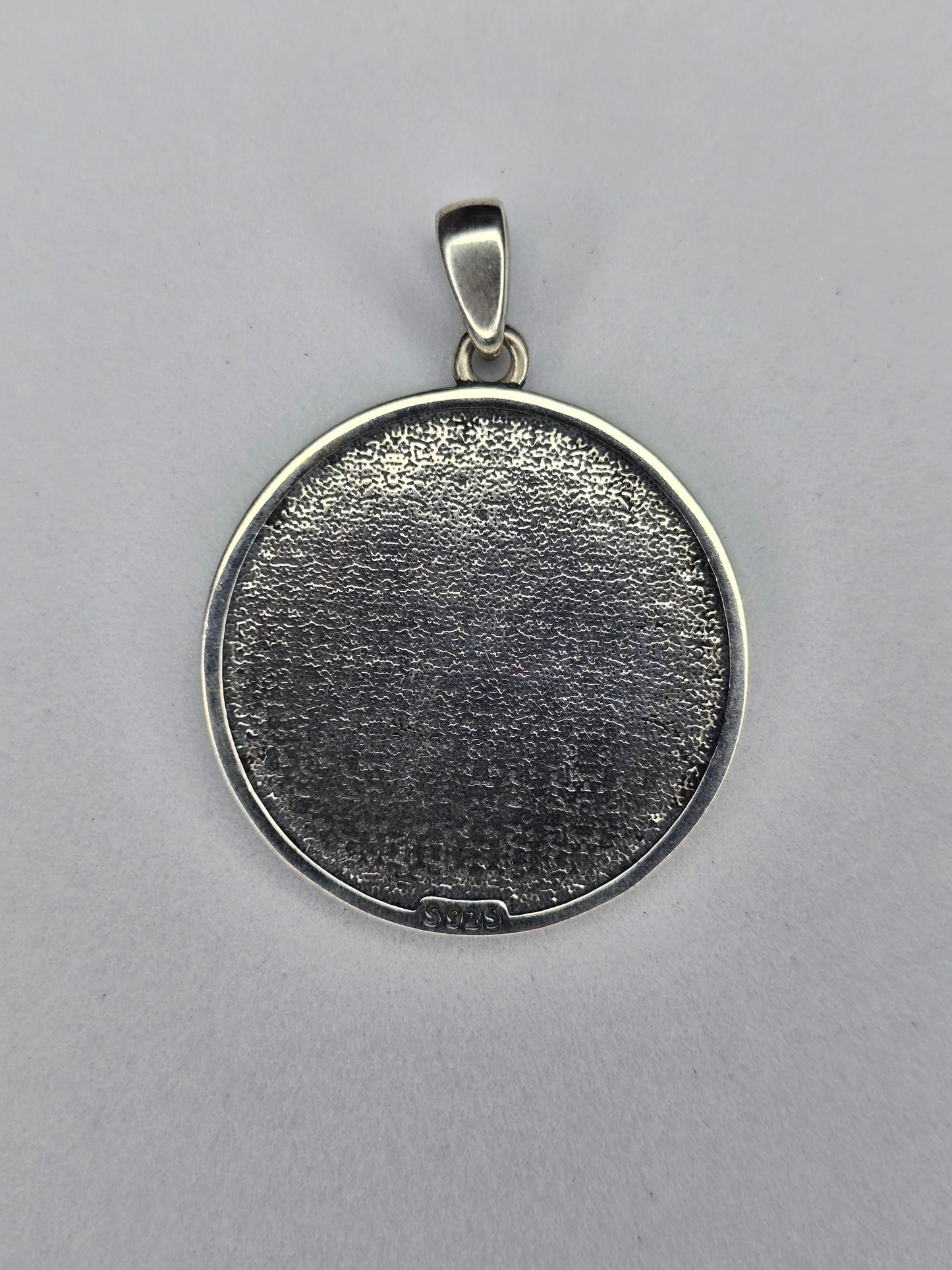 Back view of sterling silver Yin Yang dragon pendant with textured finish and 925 hallmark