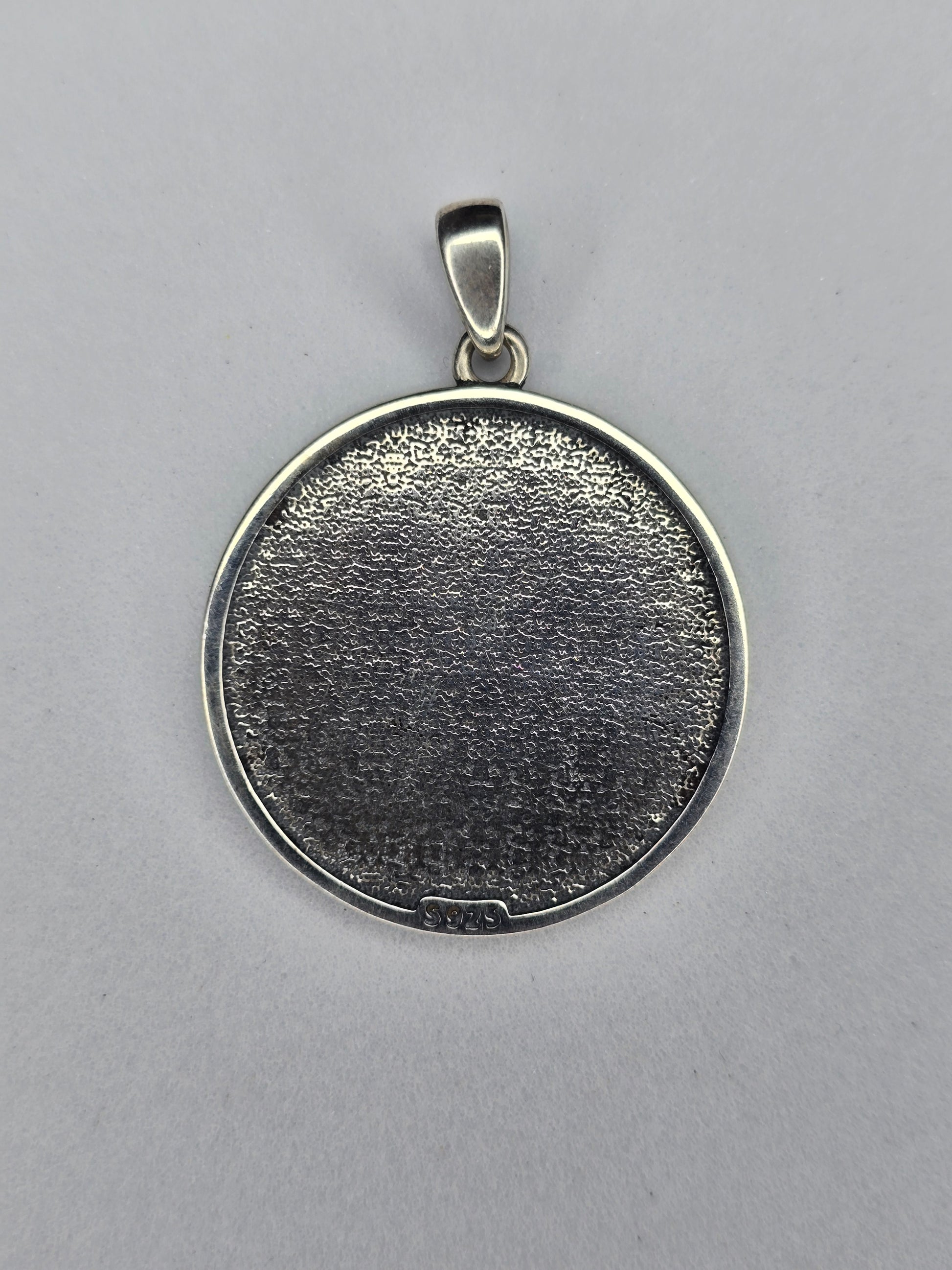 Back view of sterling silver Yin Yang dragon pendant with textured finish and 925 hallmark