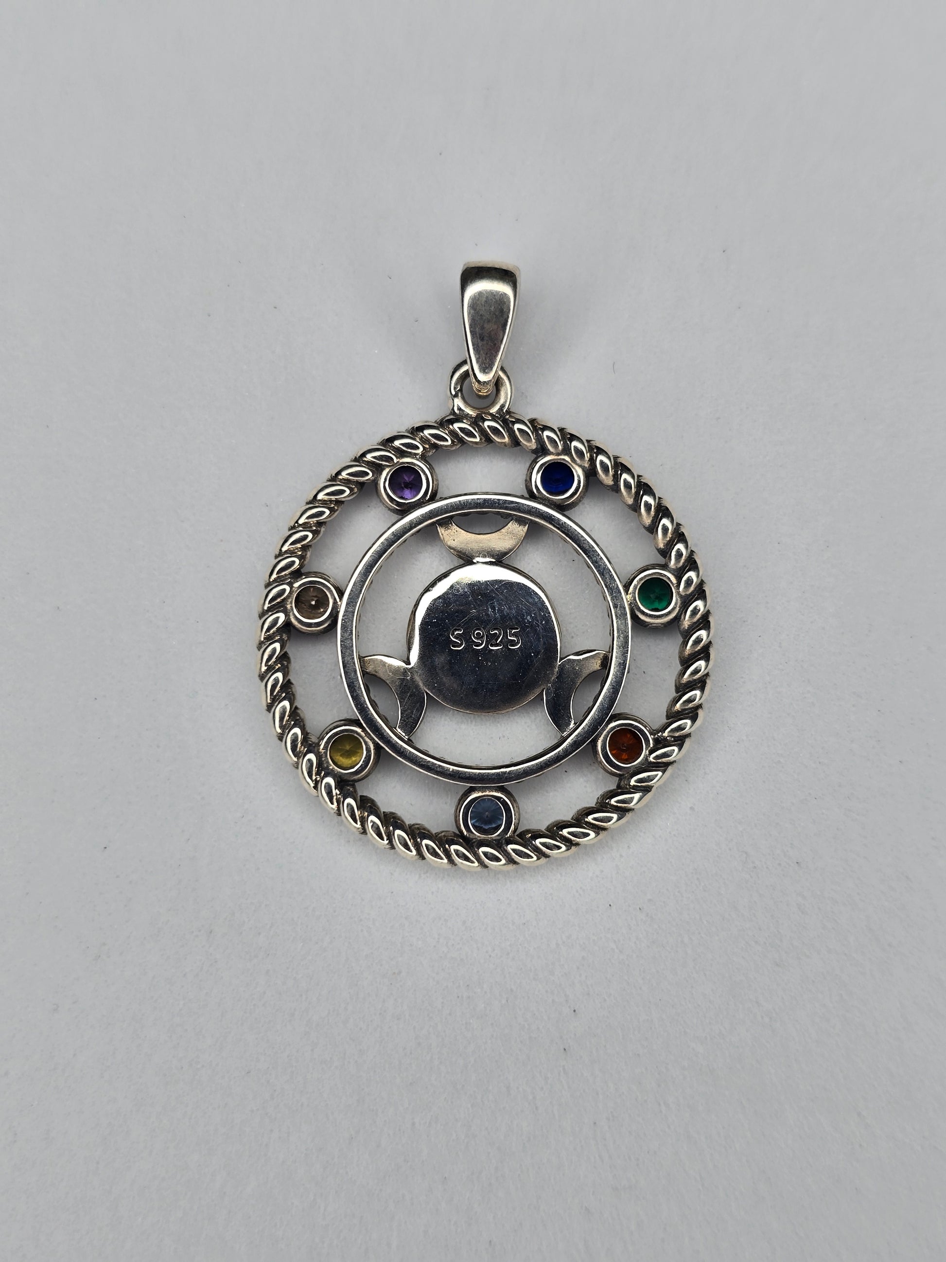 Back view of Hecate wheel pendant showing 925 sterling silver hallmark and circular triple moon design