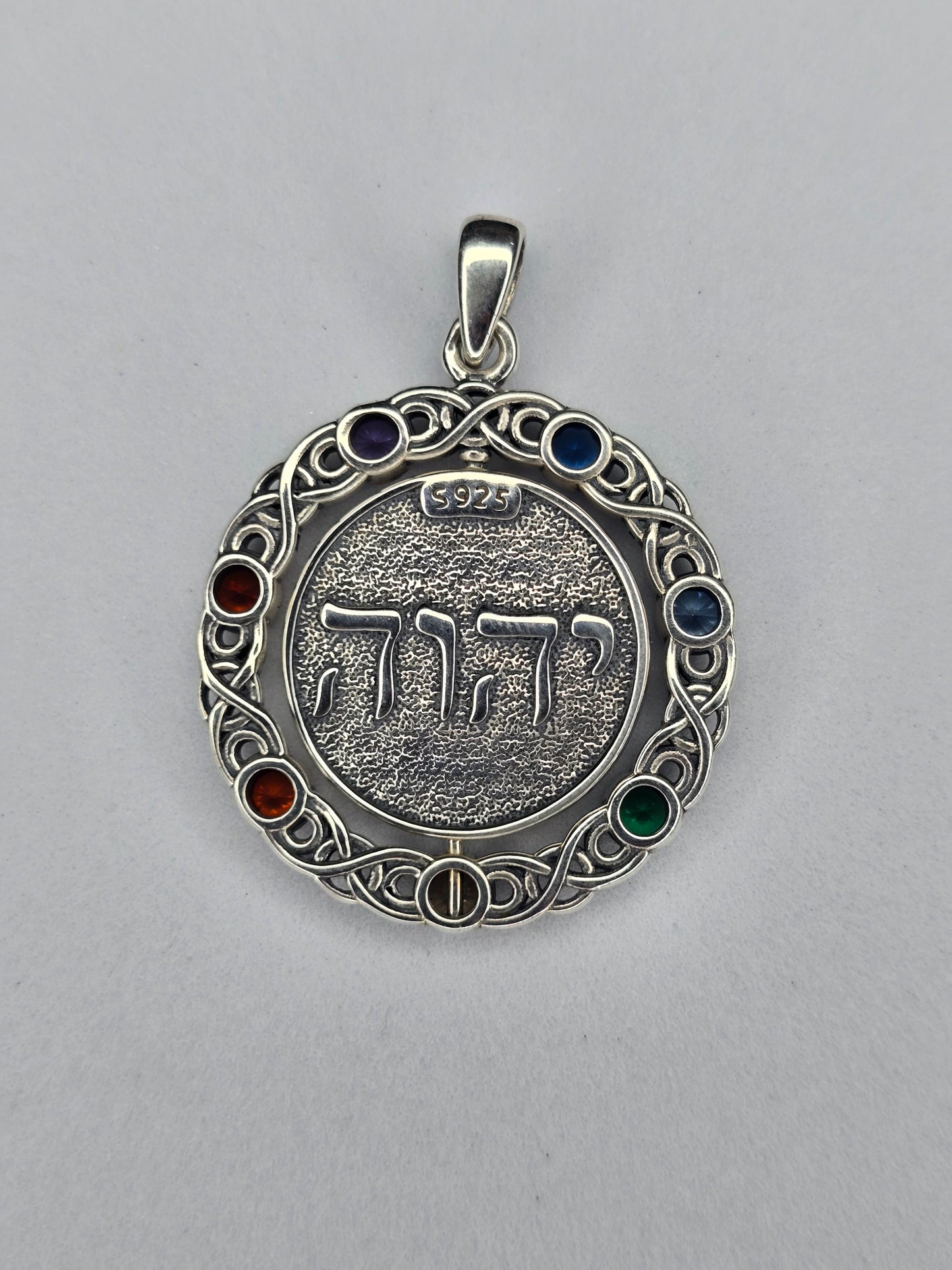Back view of rotating pentagram pendant showing sterling silver construction and chakra stones