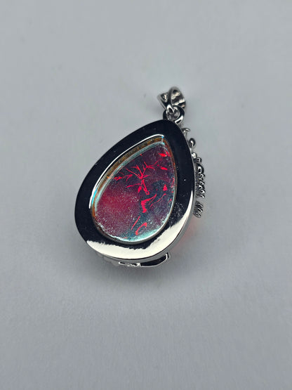 Side view of Tree of Life moonstone pendant showing teardrop silver setting and natural stone