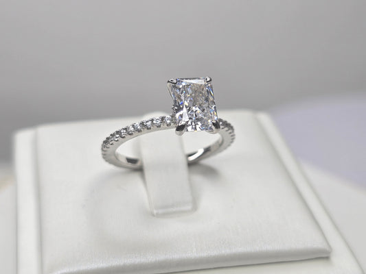 Crushed ice cut zircon ring in 925 sterling silver showing radiant main stone and pave band
