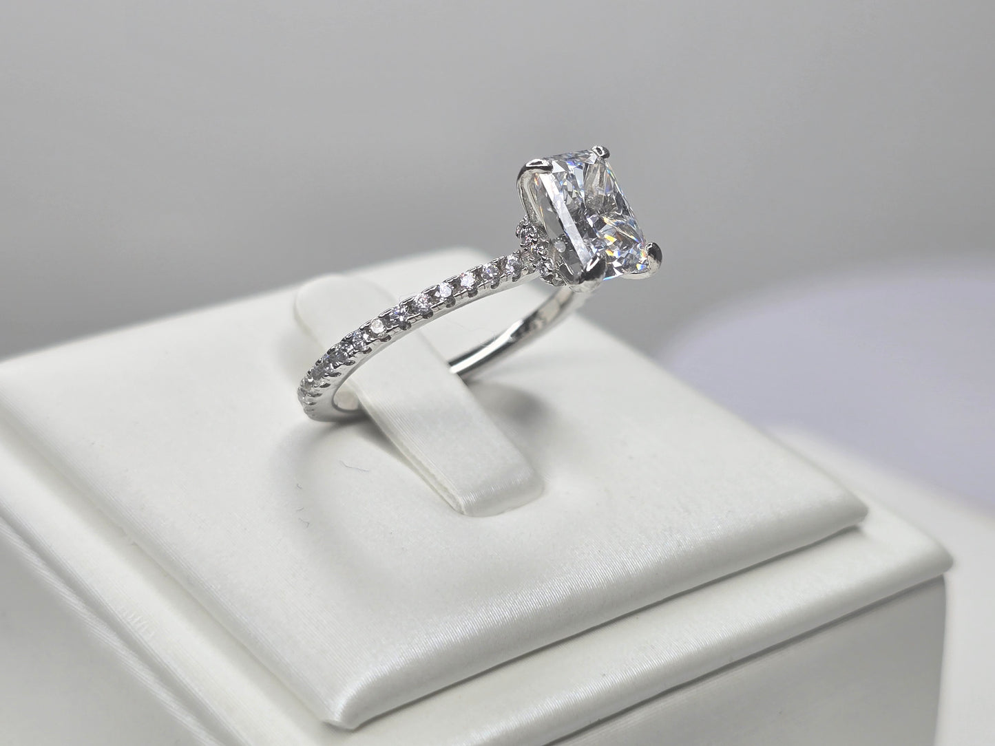 Side view of crushed ice zircon ring highlighting the elevated prong setting and accented band