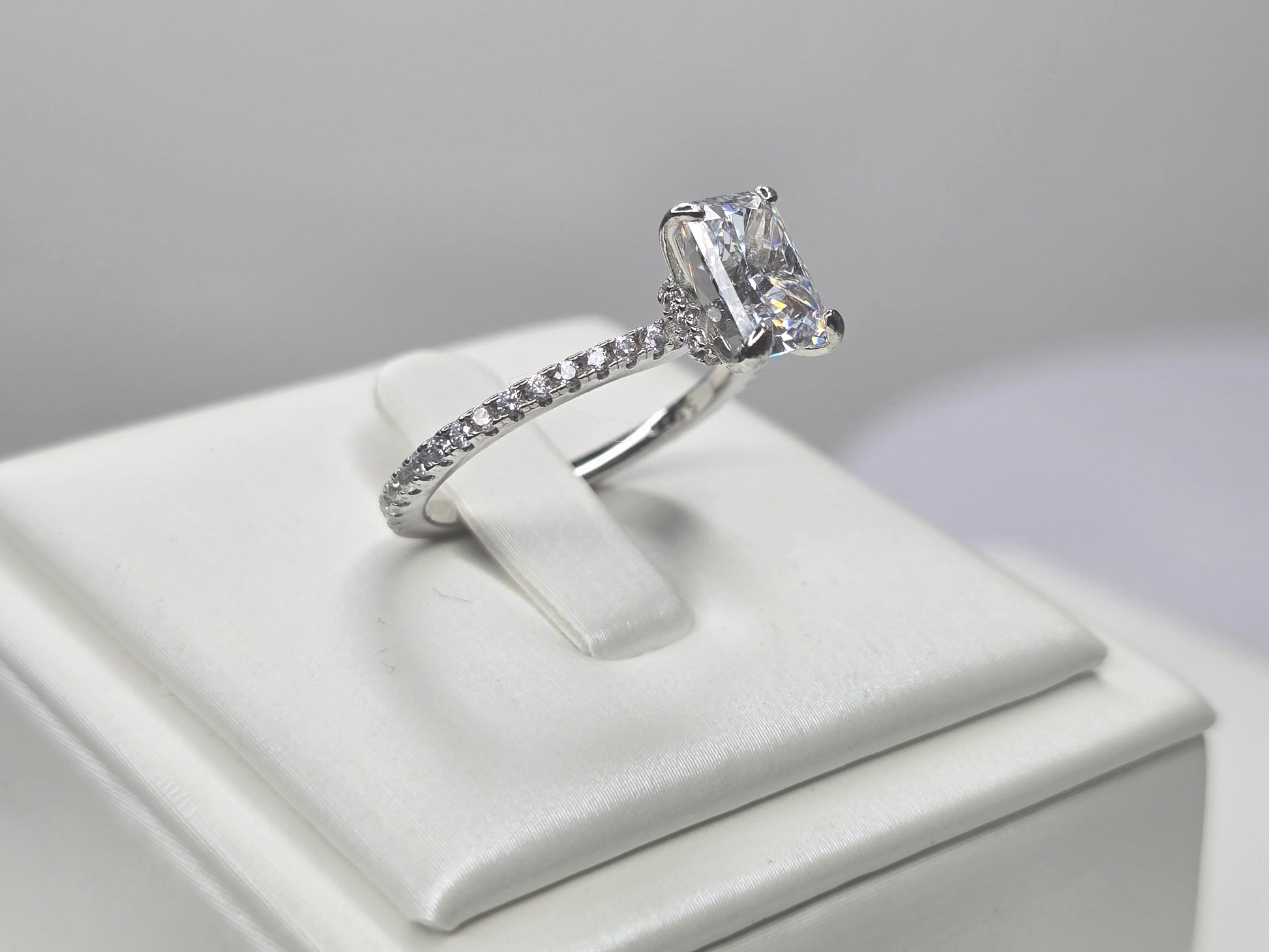 Side view of crushed ice zircon ring highlighting the elevated prong setting and accented band