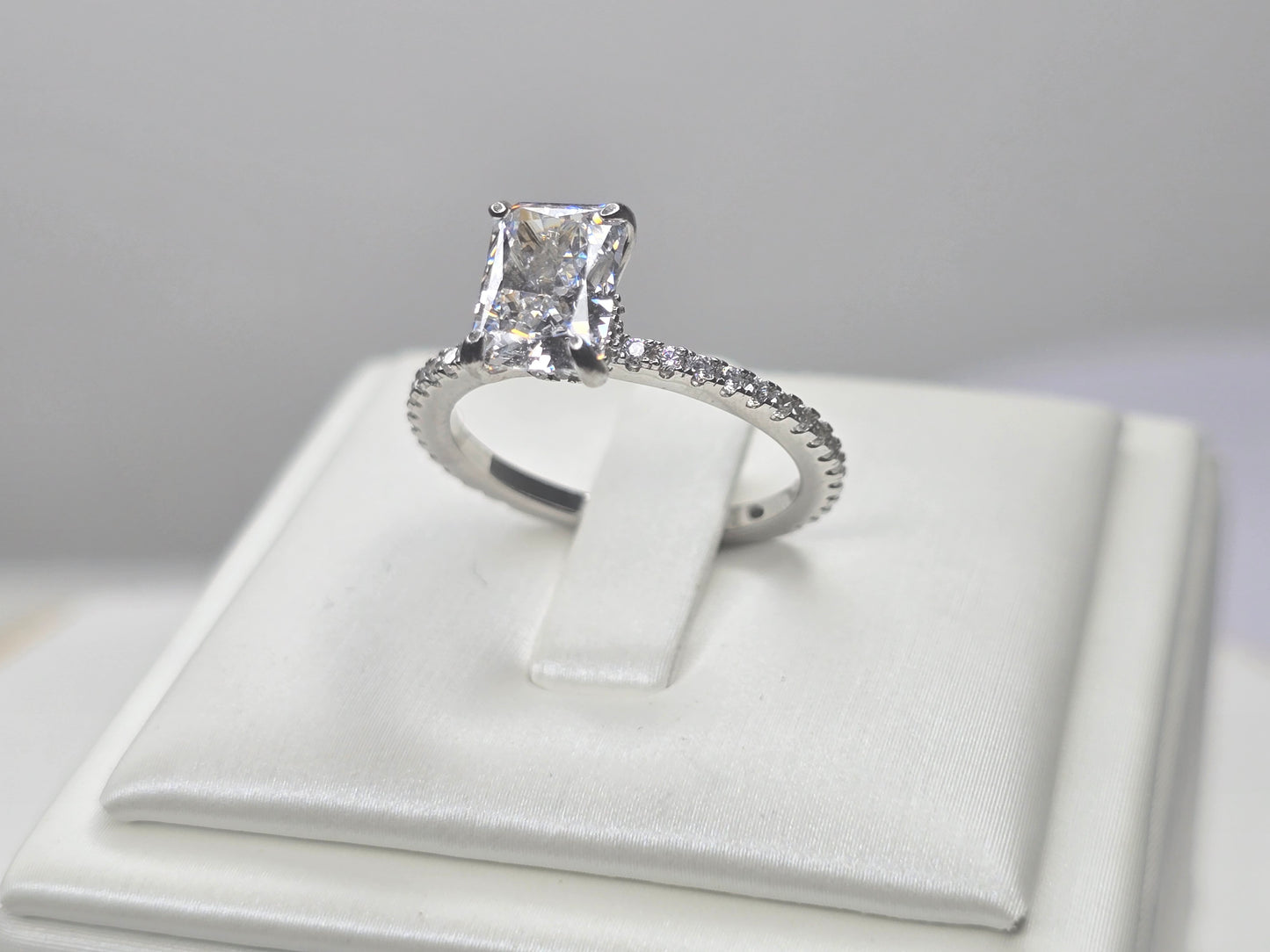 Angled view of sterling silver zircon engagement style ring showing facet light reflection
