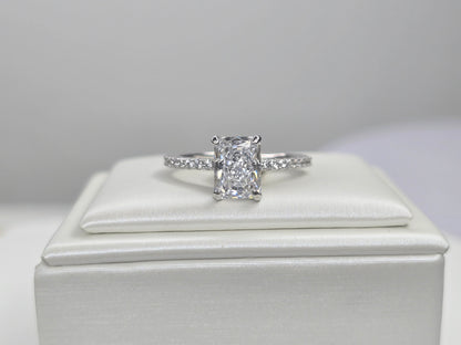 Front view of radiant cut crushed ice zircon solitaire ring on white display