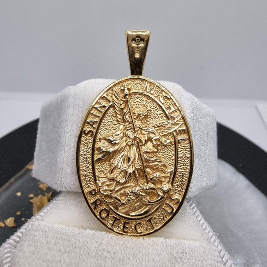 

Introducing the Saint Michael Protection Pendant, a beautifully crafted symbol of strength and faith. This stunning pendant features the image of Saint Michael, the Archangel, known as the protector against evil and the leader of the heavenly armies. Expertly plated in 18k gold, the pendant exudes a rich and timeless elegance.

The intricate detailing of Saint Michael's powerful stance is a reminder of protection and courage, making this pendant not only a stylish accessory but also a meaningful talisman.